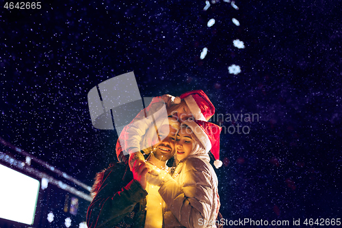 Image of Adult couple hanging out in the city during Christmas time