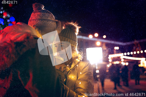 Image of Adult couple hanging out in the city during Christmas time