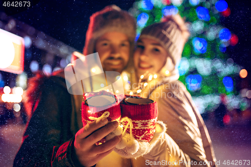 Image of Adult couple hanging out in the city during Christmas time