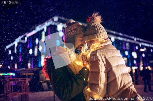 Image of Adult couple hanging out in the city during Christmas time