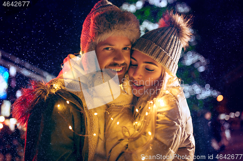 Image of Adult couple hanging out in the city during Christmas time