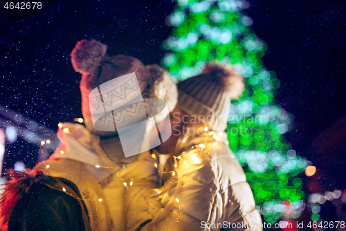 Image of Adult couple hanging out in the city during Christmas time