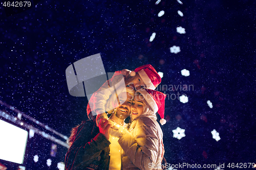 Image of Adult couple hanging out in the city during Christmas time