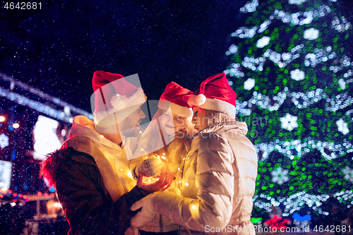 Image of family, christmas, holidays, season and people concept - happy family over city background and snow