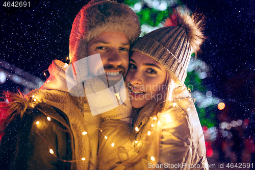 Image of Adult couple hanging out in the city during Christmas time