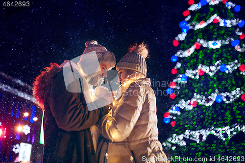 Image of Adult couple hanging out in the city during Christmas time