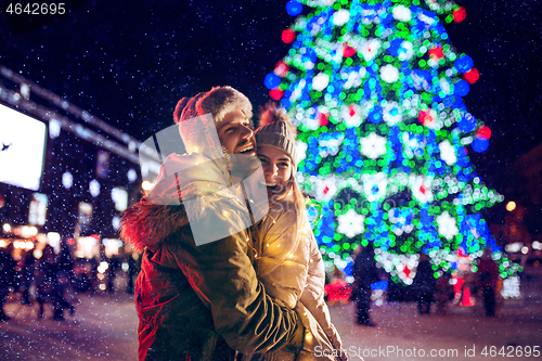 Image of Adult couple hanging out in the city during Christmas time