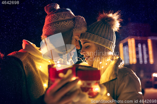 Image of Adult couple hanging out in the city during Christmas time