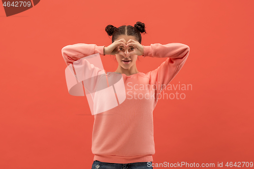 Image of Portrait of attractive cute girl with bright makeup with love isolated over coral background