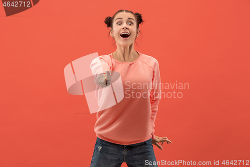 Image of The happy business woman point you and want you, half length closeup portrait on coral background.