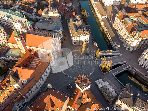 Image of Aerial drone view of Preseren Squere and Triple Bridge over Ljubljanica river,Tromostovje, Ljubljana, Slovenia. Empty streets during corona virus pandemic social distancing measures