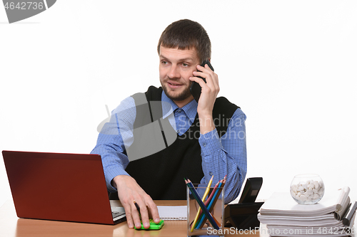 Image of Manager negotiates by phone at his workplace on a white background