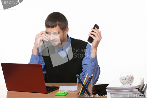 Image of dispatcher solves problems by talking on two phones