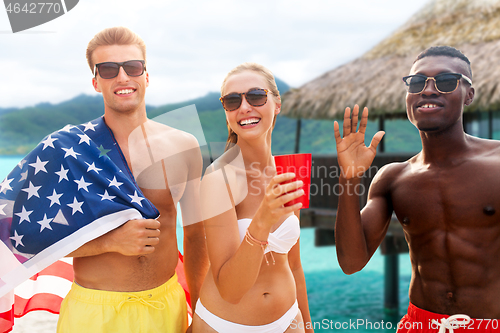 Image of friends at american independence day beach party