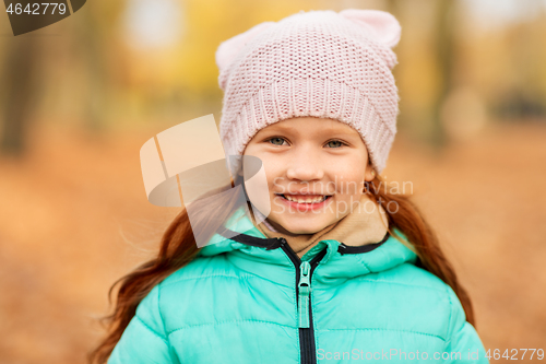 Image of portrait of happy little girl at autumn park