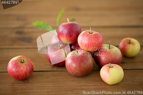Image of ripe red apples on wooden table