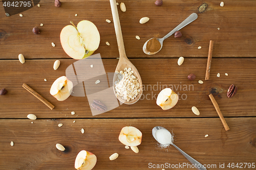 Image of apples, oatmeal, cinnamon, nuts and sugar