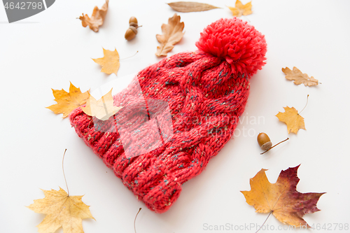 Image of hat and fallen autumn leaves on white background