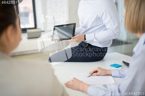 Image of close up of business team with tablet pc at office