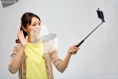 Image of asian woman taking selfie by smartphone