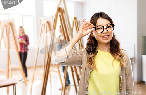 Image of happy asian woman in glasses or student