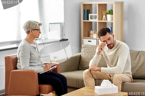 Image of senior woman psychologist and crying man patient