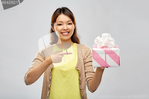 Image of african american woman showing birthday gift