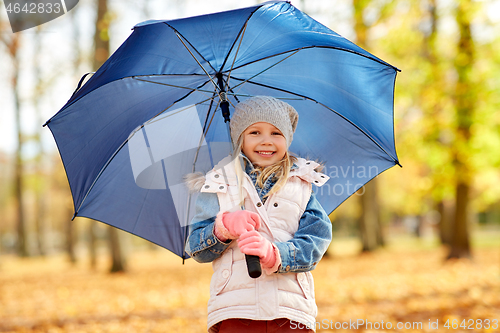 Image of happy little girl with umbrella at autumn park