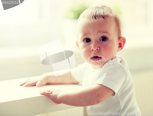 Image of happy little baby boy or girl at home