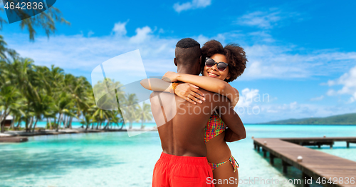 Image of african american couple hugging on summer beach