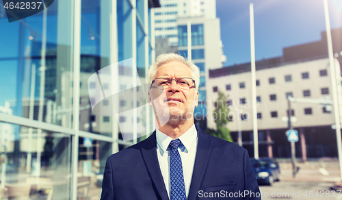 Image of senior businessman on city street