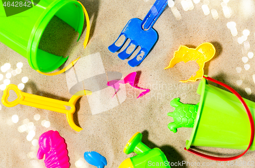 Image of close up of sand toys kit on summer beach