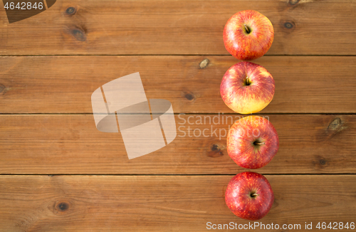 Image of ripe red apples on wooden table