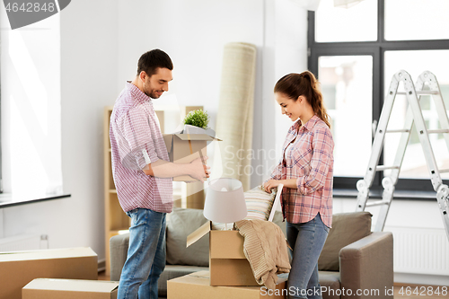 Image of happy couple with stuff moving to new home