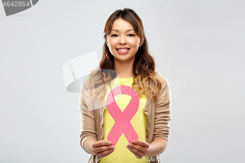 Image of asian woman with breast cancer awareness ribbon