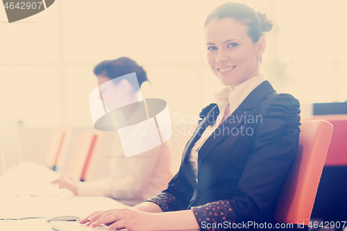 Image of business woman at  office people group in background