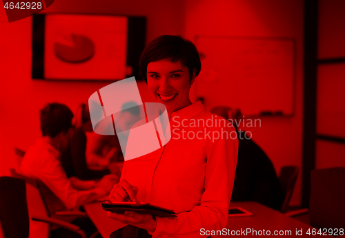 Image of hispanic businesswoman with tablet at meeting room