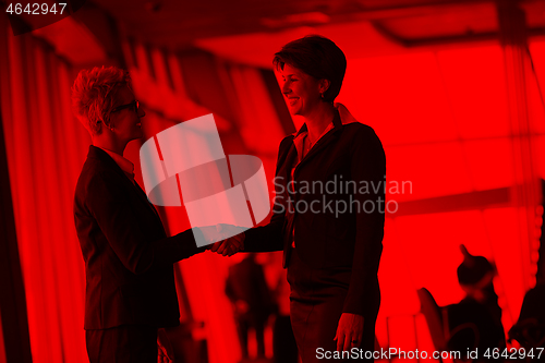 Image of business womans make deal and handshake