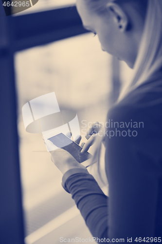 Image of business woman using smart phone at office
