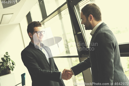 Image of cloasing the deal in modern office interior