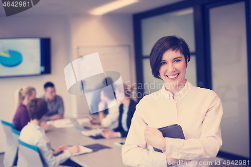 Image of hispanic businesswoman with tablet at meeting room