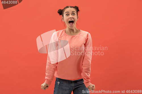 Image of Beautiful woman looking suprised isolated on coral