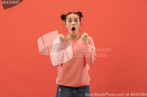 Image of Beautiful woman looking suprised isolated on coral