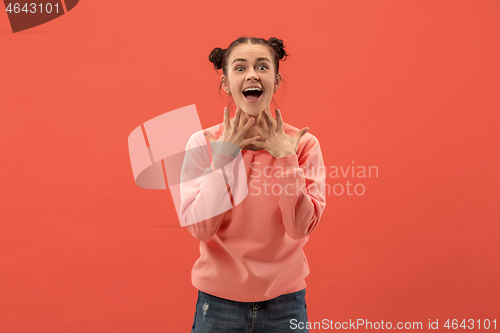 Image of Beautiful woman looking suprised isolated on coral