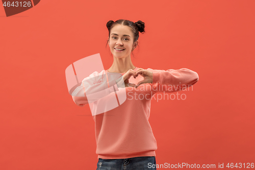 Image of Portrait of attractive cute girl with bright makeup with love isolated over coral background