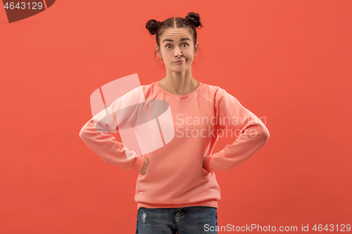 Image of Beautiful woman looking suprised and bewildered isolated on coral