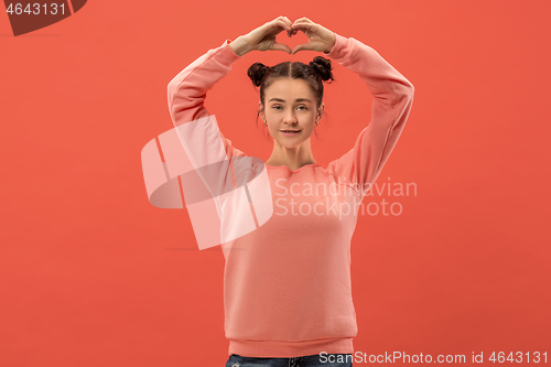 Image of Portrait of attractive cute girl with bright makeup with love isolated over coral background