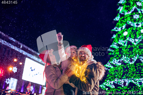 Image of family, christmas, holidays, season and people concept - happy family over city background and snow