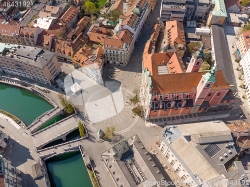 Image of Aerial drone view of Preseren Squere and Triple Bridge over Ljubljanica river,Tromostovje, Ljubljana, Slovenia. Empty streets during corona virus pandemic social distancing measures