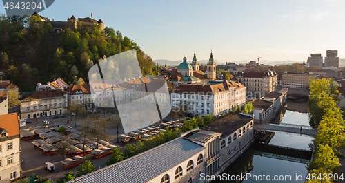 Image of Aerial drone panoramic view of Ljubljana medieval city center, capital of Slovenia in warm afternoon sun. Empty streets during corona virus pandemic social distancing measures